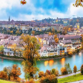 Fabulous autumn view of Bern city on Aare river during evening with Pont de Nydegg bridge , cathedral of Bern and Nydeggkirche - Protestant church. Location: Bern, Canton of Bern, Switzerland, Europe